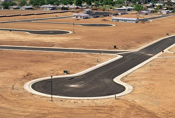 Aerial view of a construction site with a road, showcasing Property & Land Assembly Development activities.