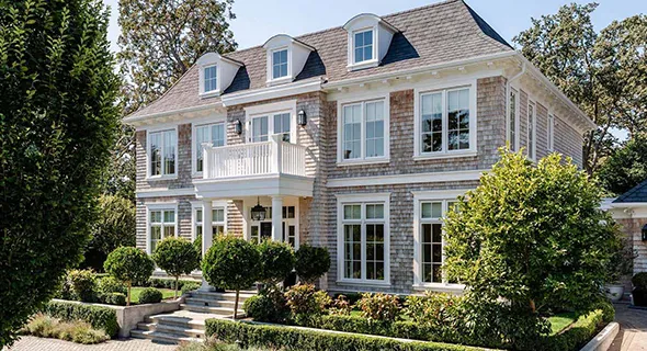 A spacious house featuring a driveway and walkway, representing House Development Services.