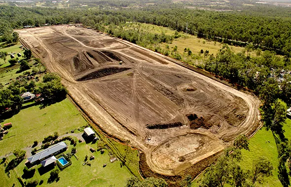 Overhead view of a large dirt field, associated with Property & Land Assembly Development efforts.