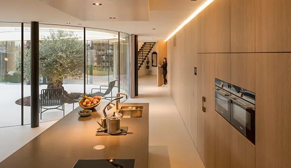 Stylish living room with large windows and a patio, creating an inviting space for entertaining and enjoying the outdoors.