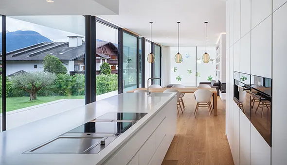 Modern kitchen featuring a large window with stunning mountain views, perfect for upscale living and entertaining.
